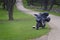 A black motorcycle with luggage parked on a rural Texas Hill Country road