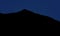 Black mountain silhouette in phantom blue night sky many stars long exposure dark highland abstract background landscape