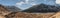 Black mountain with snow on the top and brown mountain with glacial trace on yellow stone ground at Thangu and Chopta valley.