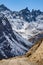 Black mountain with snow on the top and yellow stone ground at Thangu and Chopta valley in winter in Lachen. North Sikkim, India