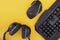 Black mouse, the keyboard, the headphones are isolated on a yellow background, the top view. gamer background