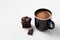 Black mug with hot chocolate served with chunks of dark chocolate