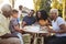 Black multi generation family eating at a table in garden