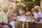 Black multi generation family eating at a table in garden