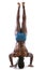 Black muscular man doing head-stand