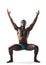 Black muscular man doing yoga exercises