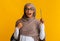 Black muslim girl in hijab and eyeglasses raising pencil, having idea