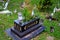Black Muslim Malay grave with flowers and Arabic Koran verses Kuching Sarawak Malaysia