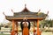 Black muslim woman meditating qigong near chinese arbor. African woman does chinese sport training outdoor.