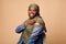 Black Muslim Woman Showing Arm After Coronavirus Vaccination, Beige Background