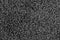 Black natural fleece carpet texture background. Dark wool fabric texture. fragment gray shaggy mat