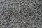 Black natural fleece carpet texture background. Dark wool fabric texture. fragment gray shaggy mat