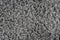 Black natural fleece carpet texture background. Dark wool fabric texture. fragment gray shaggy mat