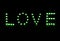 Black night with the word and text love written in brightly lit letters in green