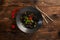 Black noodles with marbled beef on a wooden background