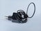 black notebook charger adapter with long cable rolled up and taped
