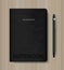 Black notebook and metallic pencil on wood background. Vector