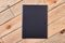 Black notepad on light wood.