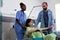 Black nurse transporting pregnant woman in wheelchair