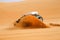 Black off-road car fetching a dune, Libya - Africa