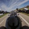 Black old motorbike travelling on a tarmac road driver point of view beautiful landscape