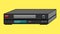 Black old vintage retro hipster antique video recorder for videotapes for watching movies on a yellow background.
