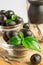 Black olives with green leaves with vintage flatware