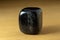 Black onyx polished gemstone from China over a wooden table