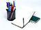 Black open small notepad, pen lie on unfold notebook, note with blank empty light pages near metallic glass stationery