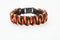 Black and orange braided bracelet on white