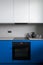 Black oven and induction hob in modern kitchen