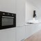 Black oven in white kitchen