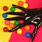 Black painted hand with multicolored balls