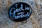 Black painted rock with message stating God is in control