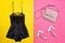 Black pajamas with lace, pink bag and white shoes. Bright pink-yellow background