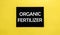 Black pancel write a text organic fertilizer on the yellow