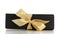 Black paper rectangle giftbox with champagne ribbon bow isolated