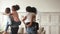 Black parents give piggyback ride carrying children playing at home