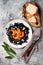 Black pasta with roasted butternut squash, parmesan cheese and fried sage. Halloween black and orange party dinner concept