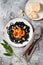 Black pasta with roasted butternut squash, parmesan cheese and fried sage. Halloween black and orange party dinner concept