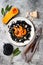 Black pasta with roasted butternut squash, parmesan cheese and fried sage. Halloween black and orange party dinner concept