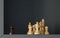 A black pawn is standing out of a group of white chess pieces