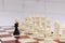 Black pawn stands in front of the exposed white chessmen. Concept of chess strategy, opposition, unequal forces