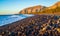 Black pebbles Kamari Avis beach Santorini island Greece