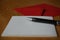 Black pen writing announcement letter with the envelope on the wooden desk