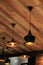 Black pendant lamp on ceiling wood