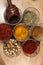Black pepper, mint, red pepper, carcuma, various spices in glassware.