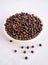 Black pepper whole peppercorn seeds grains kali mirch hot indian spice heap in a bowl natural food closeup view image stock photo