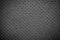 Black perforated leather texture background.