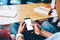 Black person browsing smartphone at table on meeting